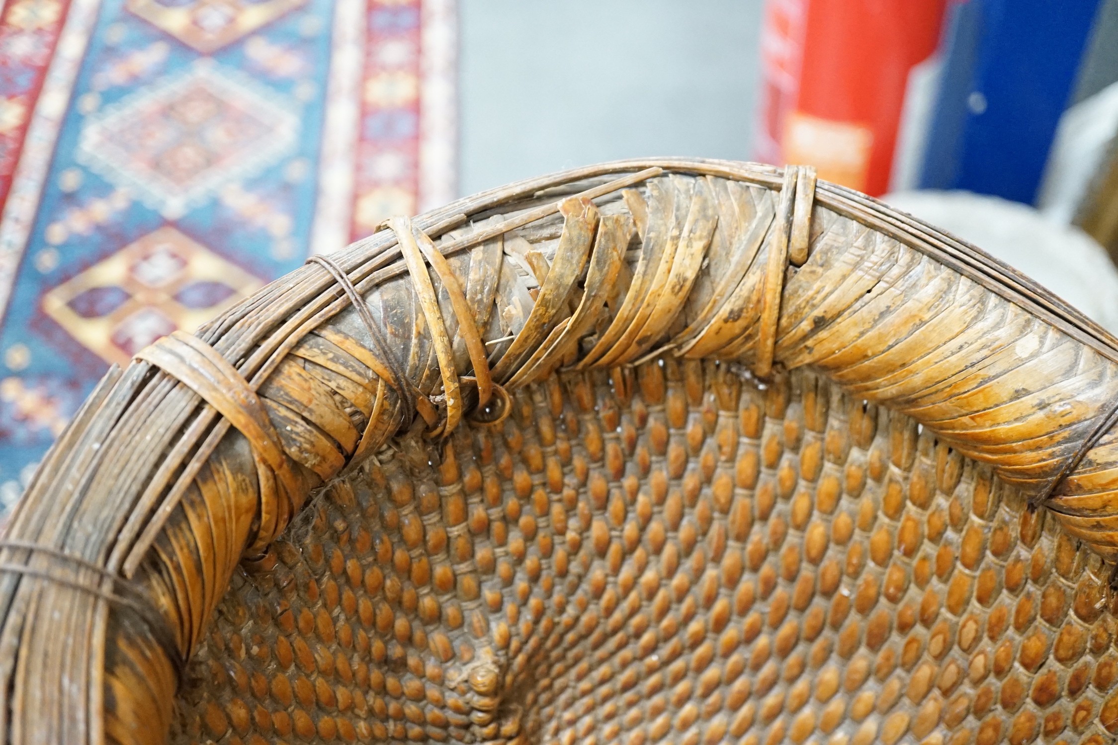 A brass mounted Chinese wicker trug basket. 67cm long